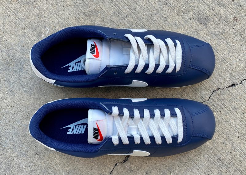 navy blue and white cortez